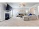 Inviting living room boasting a fireplace, neutral carpet and a large sectional sofa at 8045 Hillside Climb Way, Snellville, GA 30039
