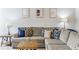 Comfortable living room with a large sectional sofa, side tables, and artwork at 8045 Hillside Climb Way, Snellville, GA 30039