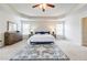 Spacious main bedroom features tray ceiling and natural light at 8045 Hillside Climb Way, Snellville, GA 30039