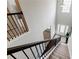 Carpeted staircase with dark metal railing and abundant natural light at 8045 Hillside Climb Way, Snellville, GA 30039