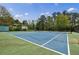 Community tennis court on a sunny day with trees and a building in the background at 8045 Hillside Climb Way, Snellville, GA 30039