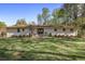 Backyard showcasing a patio dining set, landscaping, and expansive lawn perfect for outdoor enjoyment at 1384 Windburn Dr, Marietta, GA 30066