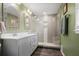 This bathroom features a double vanity, a large glass-enclosed shower, and decorative mirrors at 1384 Windburn Dr, Marietta, GA 30066