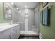 Updated bathroom with a glass enclosed shower, double vanity and gray subway tile at 1384 Windburn Dr, Marietta, GA 30066
