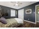 Comfortable bedroom with a ceiling fan, hardwood floors, and a closet at 1384 Windburn Dr, Marietta, GA 30066