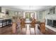 Dining area with chandelier, bar access, brick fireplace and view to the backyard at 1384 Windburn Dr, Marietta, GA 30066