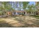 Charming single-story home with white brick, a covered carport, and a well-manicured front yard at 1384 Windburn Dr, Marietta, GA 30066