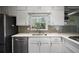 Bright kitchen featuring white cabinets, stainless steel appliances, and light countertops at 1384 Windburn Dr, Marietta, GA 30066