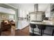 This open kitchen offers a gas cooktop, stainless appliances, and bar seating in a well-lit space at 1384 Windburn Dr, Marietta, GA 30066