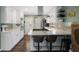 A well-lit kitchen features white cabinets, stainless steel appliances, and a center island with bar seating at 1384 Windburn Dr, Marietta, GA 30066