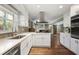 Modern kitchen boasts white cabinets, stainless appliances, and a large window for natural light at 1384 Windburn Dr, Marietta, GA 30066