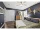 A bedroom featuring dark walls, wood floors, a ceiling fan, and ample closet space at 1384 Windburn Dr, Marietta, GA 30066