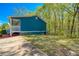 Well-maintained backyard of the house with blue siding and green forest at 166 Rustin Dr, Dallas, GA 30157