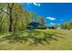 Large backyard and storage shed, surrounded by mature trees at 166 Rustin Dr, Dallas, GA 30157