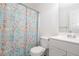 Cozy bathroom featuring a toilet, sink, and bathtub with a floral shower curtain at 166 Rustin Dr, Dallas, GA 30157