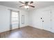 A bright bedroom featuring hardwood floors, a ceiling fan and large window at 166 Rustin Dr, Dallas, GA 30157