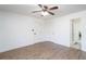 Bright bedroom featuring hardwood floors, ceiling fan and two doors to closets/bath at 166 Rustin Dr, Dallas, GA 30157