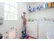 Convenient laundry room with a washer, dryer, utility sink, and exterior access at 166 Rustin Dr, Dallas, GA 30157