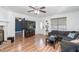 Bright living room featuring wood floors, a fireplace, large windows, and comfortable seating with modern furnishings at 166 Rustin Dr, Dallas, GA 30157