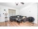 Inviting living room featuring wood floors, a comfortable sectional, and a cozy atmosphere with plenty of natural light at 166 Rustin Dr, Dallas, GA 30157