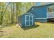 Exterior storage shed with double doors and blue and white trim at 166 Rustin Dr, Dallas, GA 30157