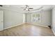 A spacious bedroom features a tray ceiling with a ceiling fan and light wood flooring at 1900 Foster Trace Ct, Lawrenceville, GA 30043