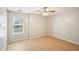 Bright bedroom with wood flooring, ceiling fan and natural light from a window overlooking trees at 1900 Foster Trace Ct, Lawrenceville, GA 30043