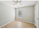 Neutral bedroom featuring light wood flooring, a ceiling fan and natural light at 1900 Foster Trace Ct, Lawrenceville, GA 30043