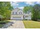 Charming two-story home boasts a well-manicured lawn, attached two-car garage, and beautiful curb appeal at 1900 Foster Trace Ct, Lawrenceville, GA 30043