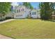 Charming two-story home featuring a well-manicured lawn and attached two-car garage at 1900 Foster Trace Ct, Lawrenceville, GA 30043