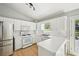 Bright kitchen features white cabinetry and stainless steel appliances at 1900 Foster Trace Ct, Lawrenceville, GA 30043