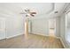 Spacious primary bedroom boasting wood floors, tray ceilings, ceiling fan and natural light at 1900 Foster Trace Ct, Lawrenceville, GA 30043