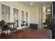 Tiled balcony with seating, ceiling fan, and garden bed full of bright flowers visible through the white doors at 311 Peachtree Hills Ne Ave # 17C, Atlanta, GA 30305