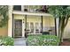 Close-up of condo balcony with black railing, seating, neutral decor, and garden bed full of bright flowers at 311 Peachtree Hills Ne Ave # 17C, Atlanta, GA 30305
