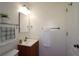 Clean bathroom with white walls, a wooden vanity, and decorative towels at 311 Peachtree Hills Ne Ave # 17C, Atlanta, GA 30305