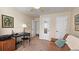 Spare bedroom featuring a futon, black desk and chair, neutral color scheme, doors, and wall art at 311 Peachtree Hills Ne Ave # 17C, Atlanta, GA 30305