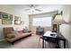 Bedroom featuring a futon, black desk and chair, neutral color scheme, window and wall art at 311 Peachtree Hills Ne Ave # 17C, Atlanta, GA 30305