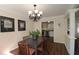 Cozy dining area with a decorative chandelier and dark wood flooring, connecting to the kitchen at 311 Peachtree Hills Ne Ave # 17C, Atlanta, GA 30305