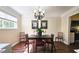 Bright dining room with neutral walls, dark wood floors, contemporary lighting, and dining table set for four at 311 Peachtree Hills Ne Ave # 17C, Atlanta, GA 30305
