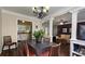 Open dining and living space with hardwood floors, decorative columns, and neutral tones at 311 Peachtree Hills Ne Ave # 17C, Atlanta, GA 30305