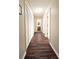 Hallway with hardwood floors and white trim, leading to a bathroom at 311 Peachtree Hills Ne Ave # 17C, Atlanta, GA 30305