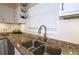 Close-up of kitchen granite countertops and stainless sink with gooseneck faucet at 311 Peachtree Hills Ne Ave # 17C, Atlanta, GA 30305