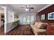 Open living room with dark wood floors, neutral walls, white trim, and view into the dining room at 311 Peachtree Hills Ne Ave # 17C, Atlanta, GA 30305