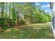Expansive backyard featuring a lush green lawn and mature trees at 3889 Elm Trace Dr, Loganville, GA 30052