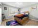 Comfortable bedroom with wood accent bed frame and modern decor at 3889 Elm Trace Dr, Loganville, GA 30052