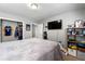 Carpeted bedroom features gray walls and closet with a dresser and wall-mounted TV at 3889 Elm Trace Dr, Loganville, GA 30052