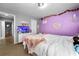 Comfortable bedroom with neutral colored carpet and stylish decorations on the lavender painted walls at 3889 Elm Trace Dr, Loganville, GA 30052