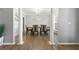 Elegant dining room featuring wood floors, wainscoting, and a modern chandelier at 3889 Elm Trace Dr, Loganville, GA 30052