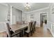 Inviting dining room featuring wood floors, columns, and an elegant chandelier at 3889 Elm Trace Dr, Loganville, GA 30052