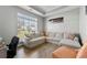 Comfortable living area featuring a large sectional sofa, natural light, and wood-look floors at 3889 Elm Trace Dr, Loganville, GA 30052